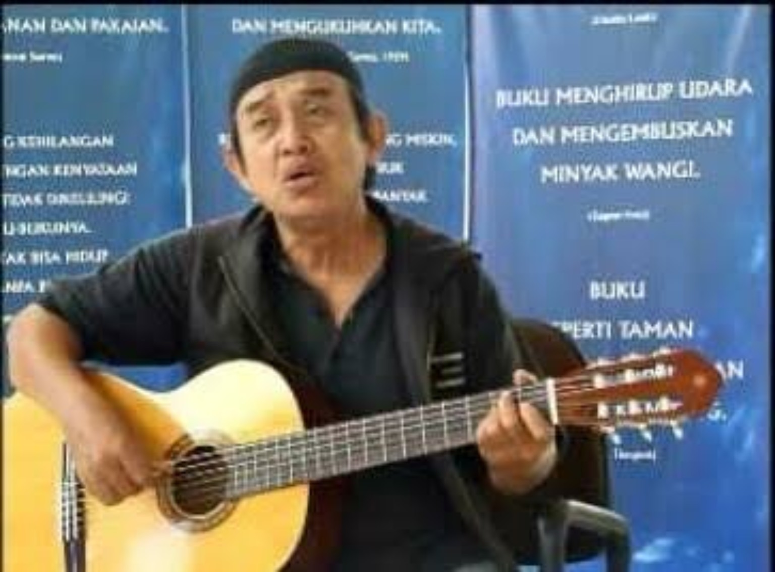 Om Jujur memainkan gitar akustik